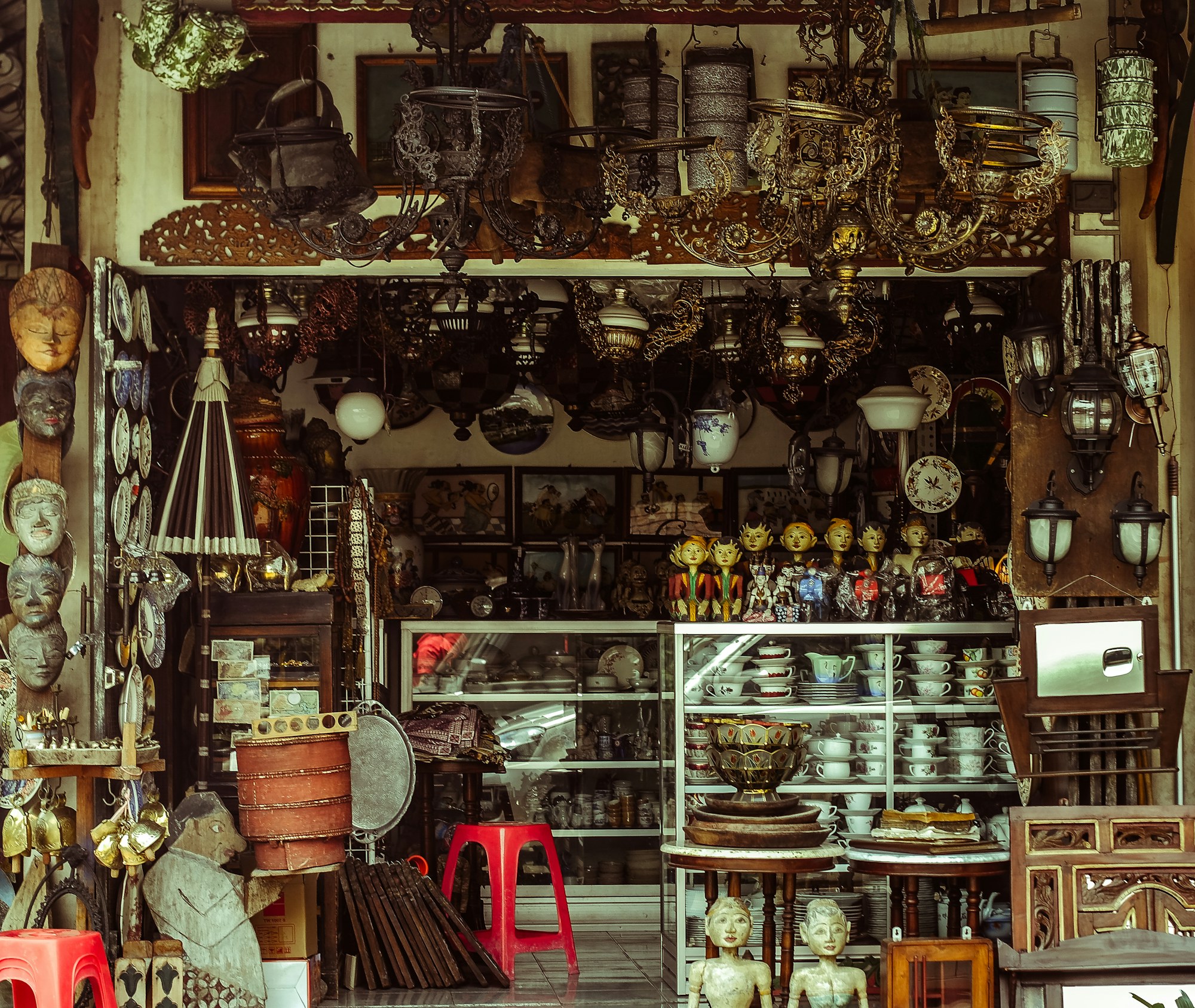 A richly stocked shop filled with furniture, lighting, and collected objects